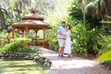 Palm Coast engagement portraits of a couple sharing an intimate moment in a beautiful outdoor park setting.