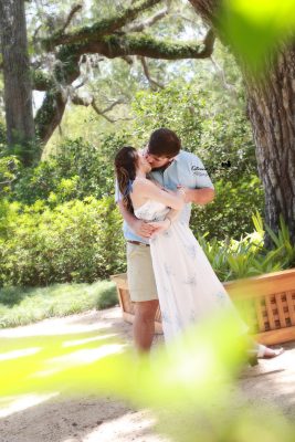 Palm Coast engagement portraits of a couple sharing an intimate moment in a beautiful outdoor park setting.