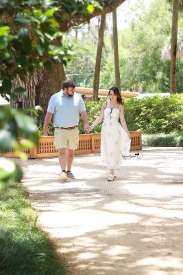 Palm Coast engagement portraits of a couple sharing an intimate moment in a beautiful outdoor park setting.