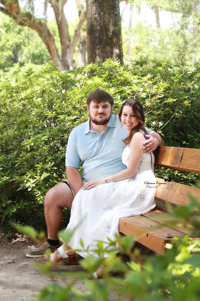 Palm Coast engagement portraits of a couple sharing an intimate moment in a beautiful outdoor park setting.