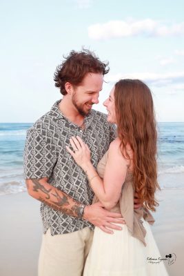Romantic engagement photography session in Palm Coast, Florida, featuring a couple embracing outdoors in natural light.