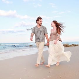 Romantic engagement photography session in Palm Coast, Florida, featuring a couple embracing outdoors in natural light.