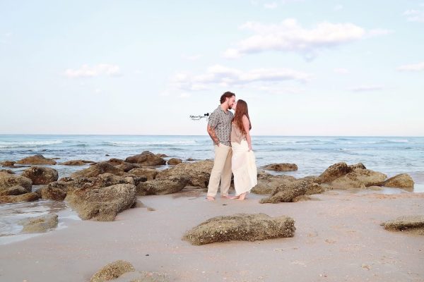 Romantic engagement photography session in Palm Coast, Florida, featuring a couple embracing outdoors in natural light.