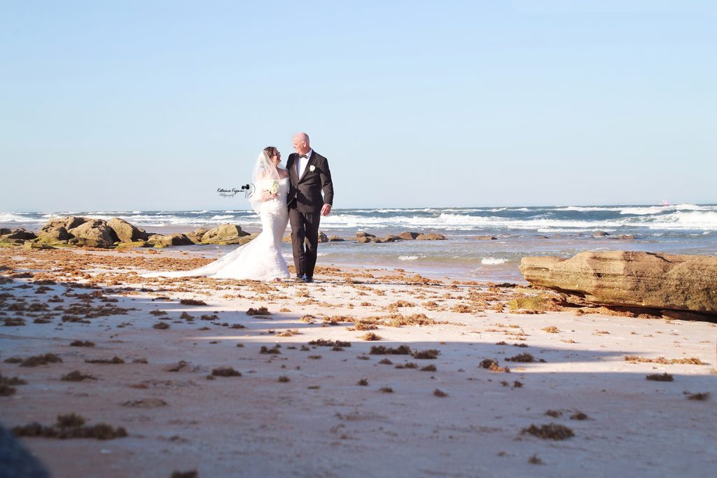 Romantic wedding photography in Palm Coast, Florida, capturing a newlywed couple at a scenic outdoor location.