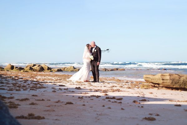 Romantic wedding photography in Palm Coast, Florida, capturing a newlywed couple at a scenic outdoor location.