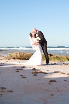Romantic wedding photography in Palm Coast, Florida, capturing a newlywed couple at a scenic outdoor location.