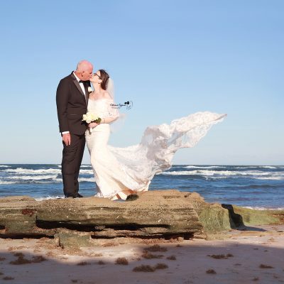 Romantic wedding photography in Palm Coast, Florida, capturing a newlywed couple at a scenic outdoor location.