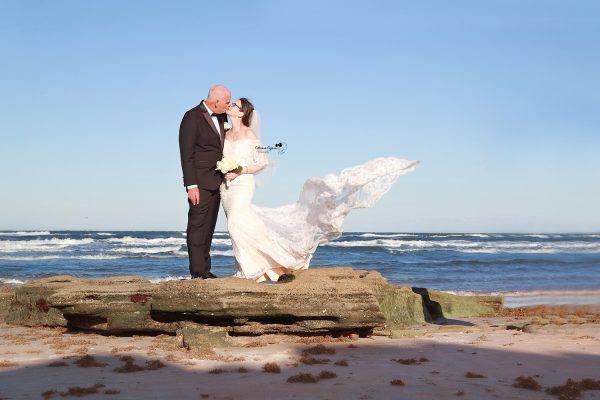 Romantic wedding photography in Palm Coast, Florida, capturing a newlywed couple at a scenic outdoor location.
