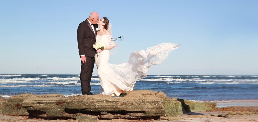 Romantic wedding photography in Palm Coast, Florida, capturing a newlywed couple at a scenic outdoor location.