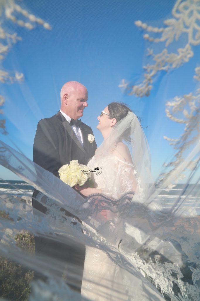 Romantic wedding photography in Palm Coast, Florida, capturing a newlywed couple at a scenic outdoor location.