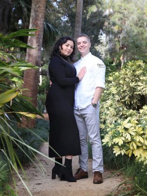 Engaged couple under oak trees at Washington Oaks Gardens.