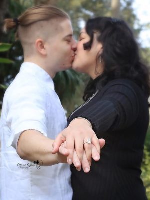 Engaged couple under oak trees at Washington Oaks Gardens.