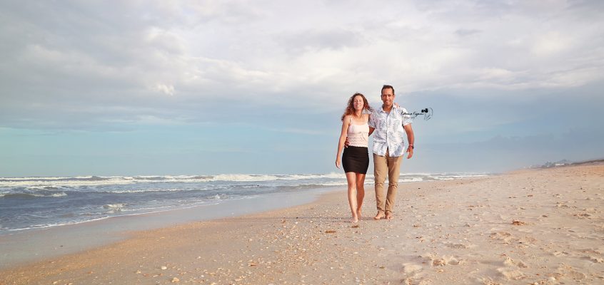 Engaged couple on the beach at Washington Oaks Gardens.