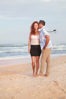 Engaged couple on the beach at Washington Oaks Gardens.