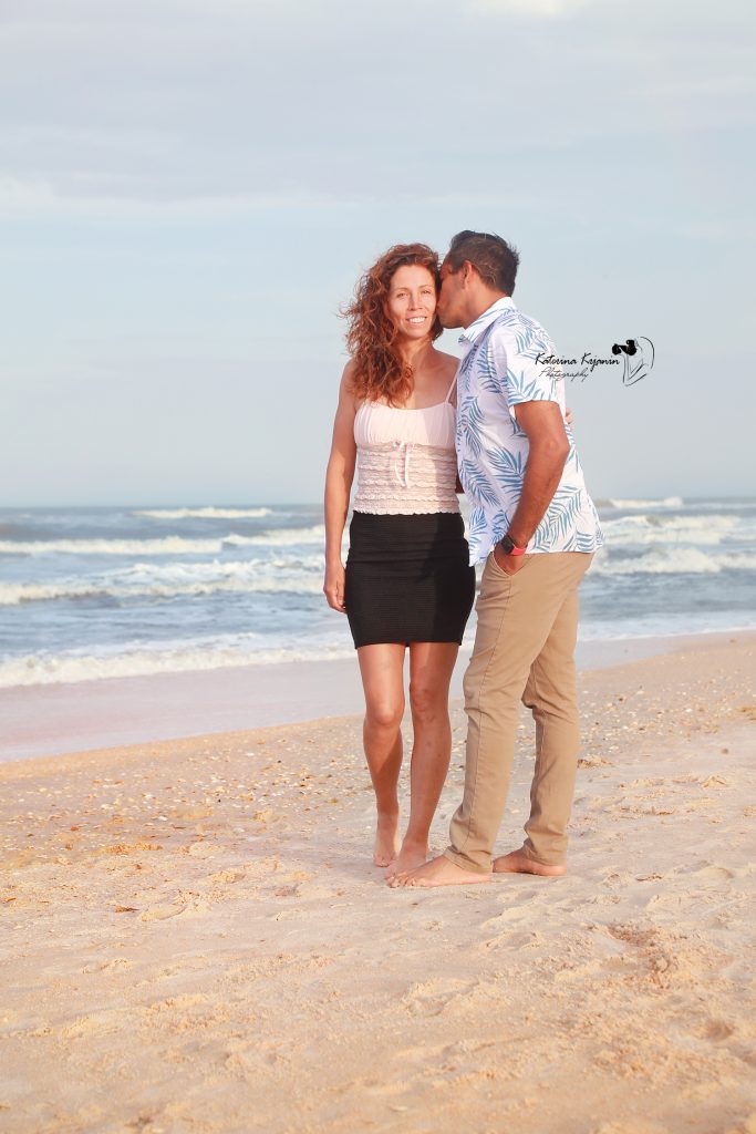 Engaged couple on the beach at Washington Oaks Gardens.