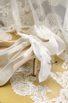 Close-up wedding photography of a wedding dress and shoes capturing the elegant details of the wedding day.