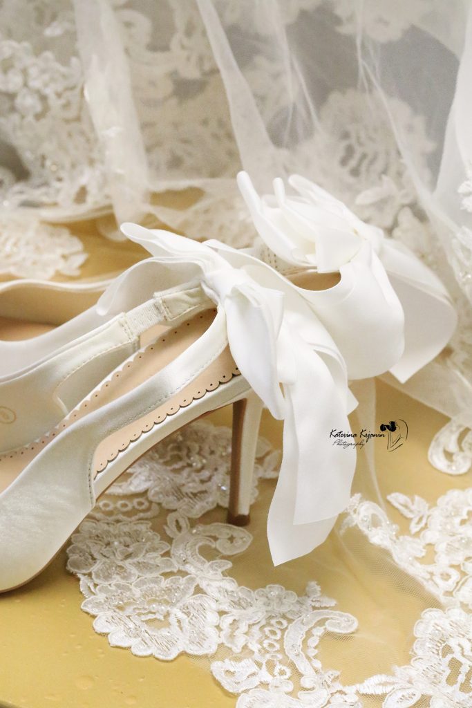 Close-up wedding photography of a wedding dress and shoes capturing the elegant details of the wedding day.