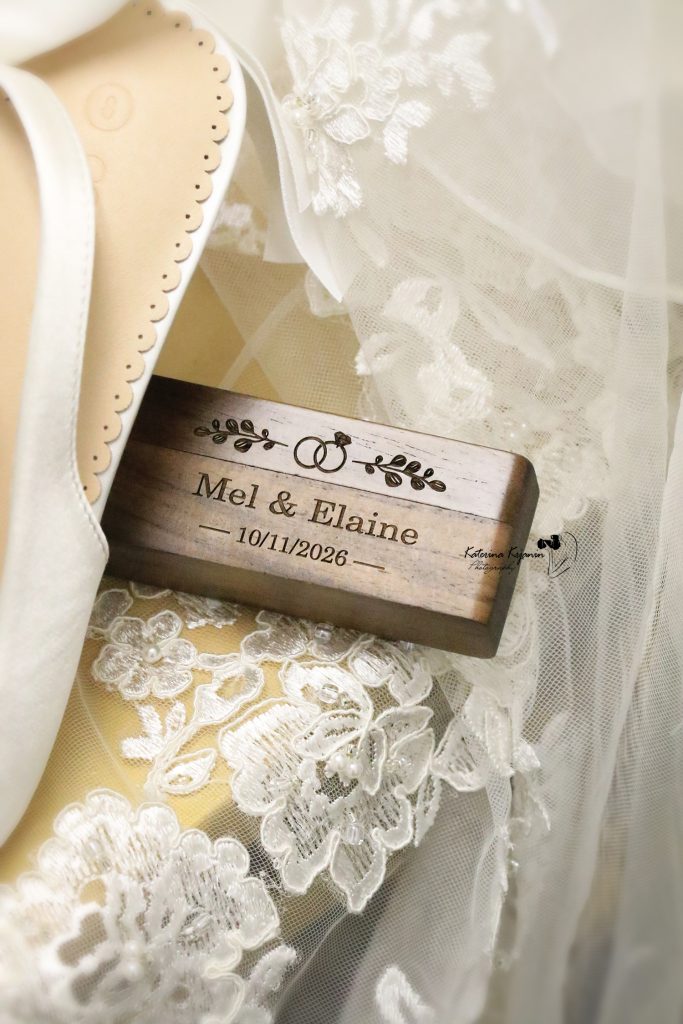 Close-up wedding photography of a wedding dress, shoes and names tag, capturing the elegant details of the wedding day.