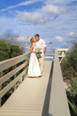 Wedding couple sharing a romantic kiss after their wedding ceremony.