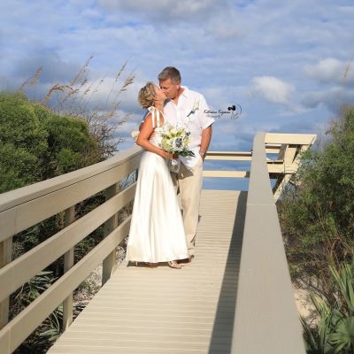 Wedding couple sharing a romantic kiss after their wedding ceremony.