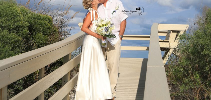 Wedding couple sharing a romantic kiss after their wedding ceremony.